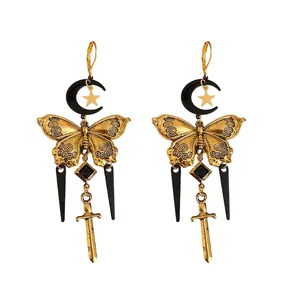 Vintage gothic earrings with gold butterfly black moon and sword charms on white background
