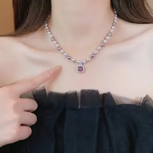 Elegant French pearl necklace with a square purple zircon pendant worn by an Asian model