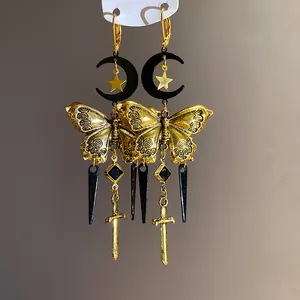 Exquisite close-up of vintage gothic butterfly earrings featuring moon, star, and sword charms