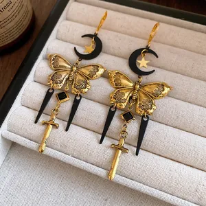 Elegant vintage gothic butterfly earrings with moon and sword charms in antique gold finish