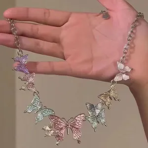 Close-up of vibrant butterfly pendants in multiple colors on a chic silver link chain necklace.
