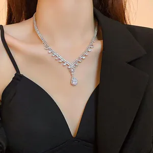 Close-up of a French style silver teardrop zircon necklace worn on a model's neck