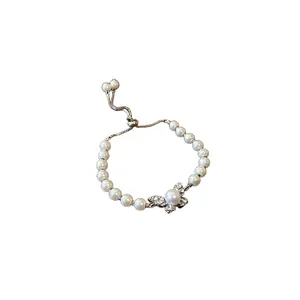 Elegant butterfly charm bracelet featuring artificial pearls and an adjustable slider chain