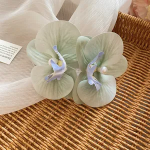 Elegant light green satin orchid flower hair clip with pearl detail