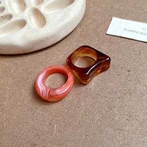 Handcrafted irregular acrylic marbled geometric rings in pink and tortoiseshell resin