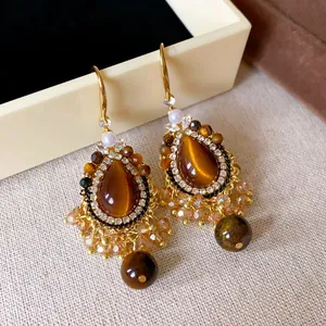 Detailed view of Maillard faux tiger eye drop earrings with intricate crystal beading.