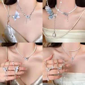 Macro view of dainty butterfly pearl necklaces with elegant rhinestone accents and tassels