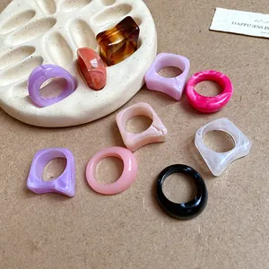Detailed view of various acrylic marbled geometric rings in assorted colors and shapes