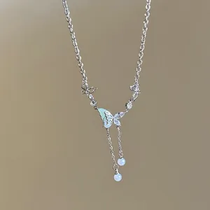 Detail view of an elegant silver necklace featuring crystal butterflies and pearl pendants