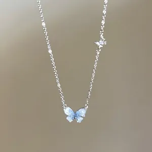 Detailed view of silver butterfly pendant necklace with sparkling micro-inlaid stones.