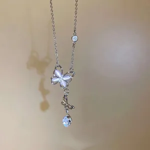 Close-up of elegant butterfly pendant necklace with sparkling stones and silver chain.