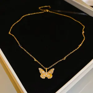 Detailed view of a gold-toned butterfly pendant necklace with sparkling crystals.