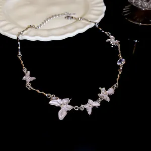 Detailed macro shot of an elegant silver butterfly necklace with pearlescent pendants