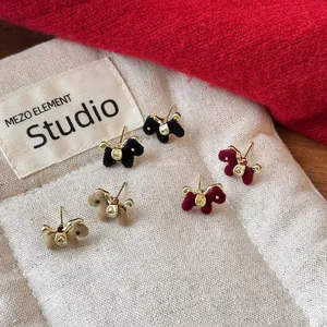 Detailed macro view showing the soft flocked texture of horse-shaped earrings in three colors