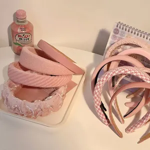 Detailed close-up of pink textured headbands in sweet Korean high skull top style