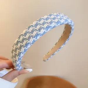 Detailed macro view of the blue and white houndstooth woven texture on a padded headband