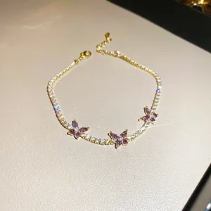 Bracelet tennis papillon doré élégant avec zircons violets et blancs étincelants