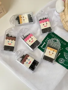Close-up detail of black bobby pins set in cute cartoon portable storage cases for hair