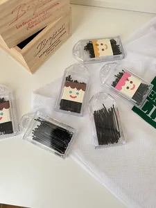 Macro view of black bobby pins sets in compact clear plastic storage cases