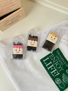Set of black bobby pins in transparent boxes with cute cartoon face cardboard inserts