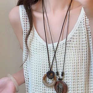 Vintage ethnic style long sweater necklace set with hollow leaf and wooden ring charms