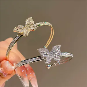 Macro view of gold-plated butterfly bracelets encrusted with sparkling zircon stones