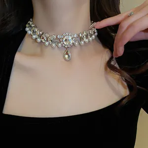 Detailed macro view of double-layer rhinestone necklace with pearls and teardrop pendant