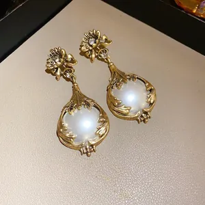 Elegant vintage palace style drop earrings featuring large faux pearls and crystal accents