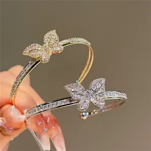 Detail shot of elegant double-layer bracelets featuring intricate zircon butterfly motifs