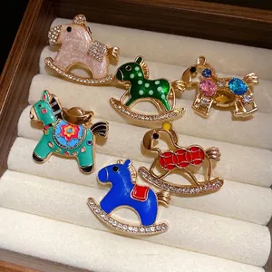 Vintage enamel horse brooches with sparkling rhinestones in a luxury jewelry box