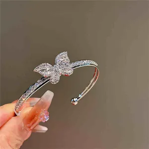 Detailed view of a silver-toned double-layer bangle featuring a sparkling zircon butterfly.