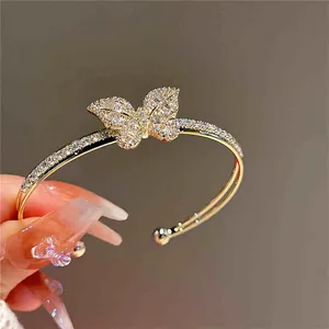Close-up of a sparkling gold-plated butterfly bracelet with double-layer open design.