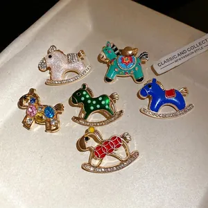 Vintage enamel rocking horse brooches with sparkling rhinestone embellishments