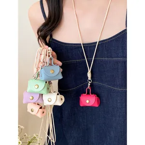 Detailed view of multiple colorful mini leather pouch necklaces shown on a female model