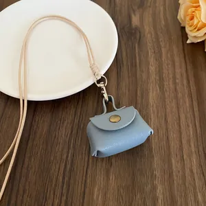 Close-up view of a cute blue mini leather coin purse necklace with long hanging cord