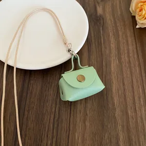 Mint green mini leather coin purse necklace with a long beige adjustable lanyard cord