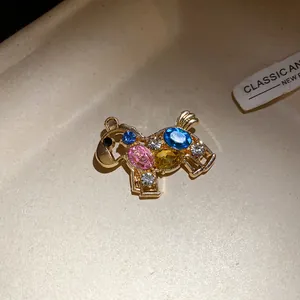 Detailed view of a luxury vintage horse brooch embellished with colorful sparkling rhinestones