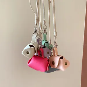 Macro view of colorful mini leather coin purse necklaces in vibrant dopamine shades.
