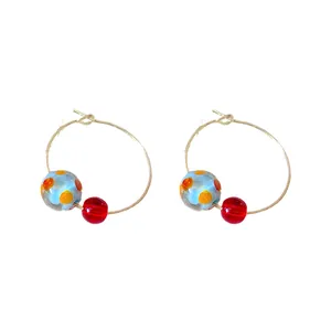 Colorful resin hoop earrings with summer vibe dainty design on white background.