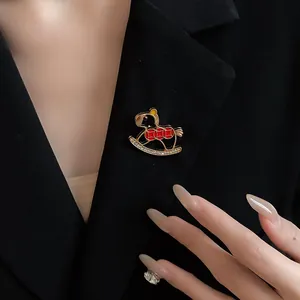 Detailed view of an elegant enamel rocking horse brooch with sparkling rhinestones.