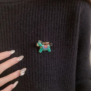Close-up of a colorful enamel horse brooch on a black knitted sweater