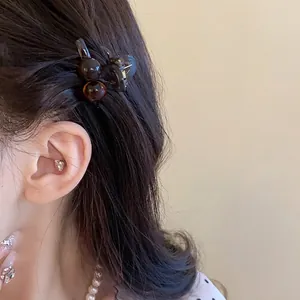 Elegant mini amber acrylic hair claw clip with vintage round bead design for women