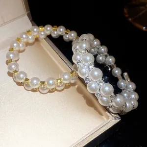Detailed view of an elegant double-layer rhinestone pearl beaded bracelet in a gift box