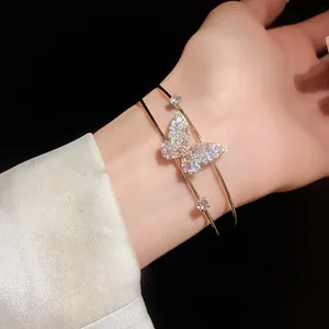 Close-up of elegant double-layered butterfly bangle featuring sparkling purple and white zircons