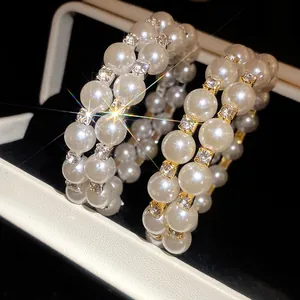 Close-up of double-layer pearl bracelet with sparkling rhinestone accents on display.