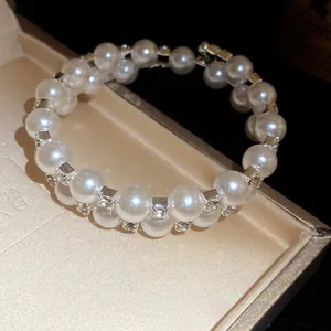 Close-up of elegant double-layer pearl bracelet with sparkling rhinestone accents