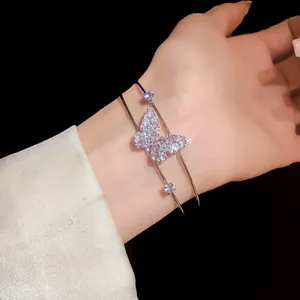Close-up of elegant double-layer butterfly bangle encrusted with pink and white zircons.