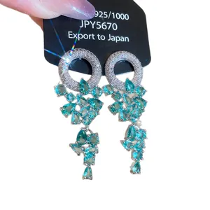 Elegant 925 silver dangle earrings featuring cyan teardrop stones and sparkling rhinestones.