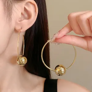 Elegant minimalist oversized gold hoop earrings with large bead detail for women