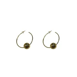 Elegant gold hoop earrings featuring a large metallic bead on a minimalist circular frame